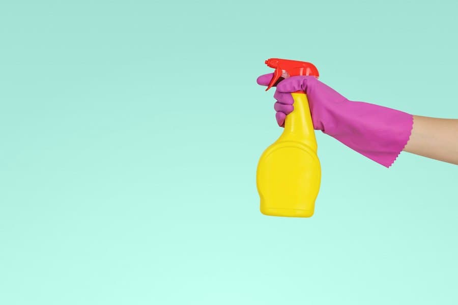 A gloved hand holding a spray bottle